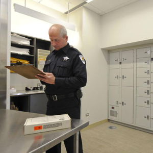 Police office checking in evidence to the secure evidence storage lockers