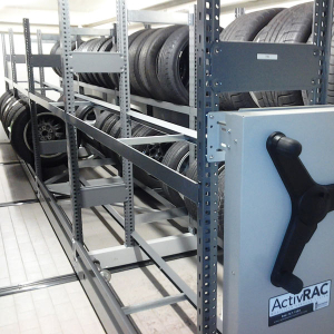 Tire storage solution on mechanical assist mobile storage at auto dealership